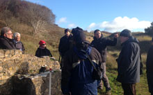 Porthcawl U3A Arfordir group and Jonathan Berry (Senior Inspector, Cadw) discussing the early rifle range at Merthyr Mawr