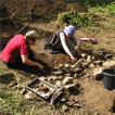 Students revealing the remains of a wall in Trench 1