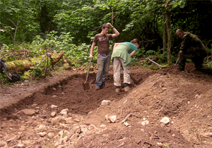 Members of the excavation team backfilling one of the trenches