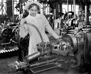 Female munitions worker operating a lathe that makes brass shell casings