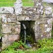 The well at Llangennith on Gower (Swansea) stands on the green just outside the 
    churchyard gate