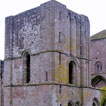 The west front of Llanthony Priory (Monmouthshire) shows the transition between 
    the massive Norman style with its round-headed openings to the beginning of the use of pointed arches and a more delicate style of building.